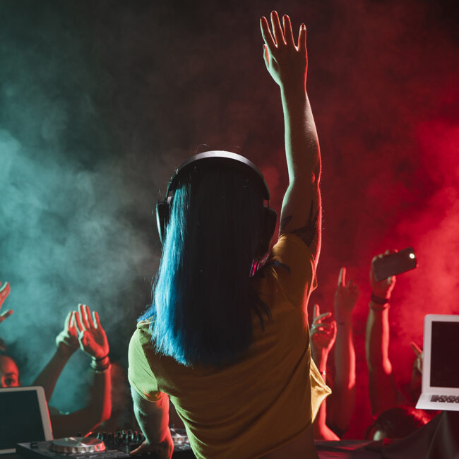 front-view-young-female-dj-entertaining-crowd Female DJ